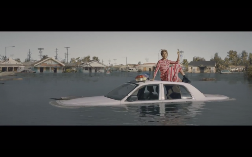 beyonce sitting on top a flooded car